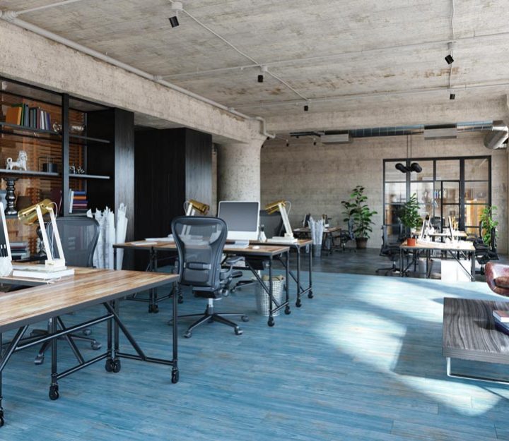 a workspace containing desks, seats, and computers while staff members are away