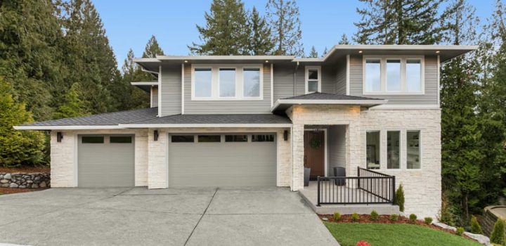 a two-story house with a driveway painted primarily in a grayish hue
